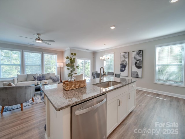 kitchen featuring light stone countertops, dishwasher, white cabinetry, sink, and a center island with sink