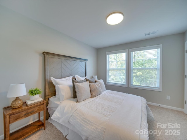 bedroom featuring light colored carpet