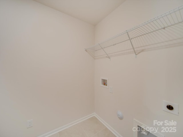 laundry room featuring electric dryer hookup, hookup for a washing machine, and light tile patterned floors