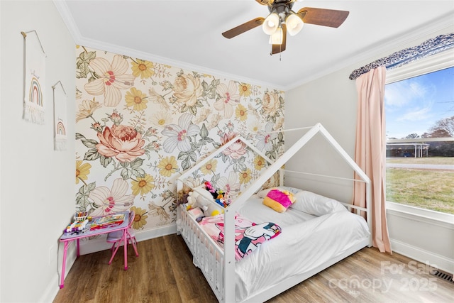 bedroom with crown molding, ceiling fan, and dark hardwood / wood-style floors