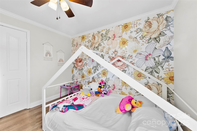 bedroom featuring crown molding, ceiling fan, and hardwood / wood-style floors