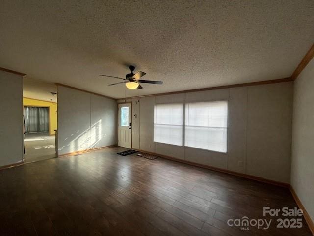 spare room with hardwood / wood-style floors, crown molding, a textured ceiling, and ceiling fan