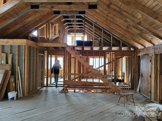 miscellaneous room featuring vaulted ceiling and hardwood / wood-style flooring