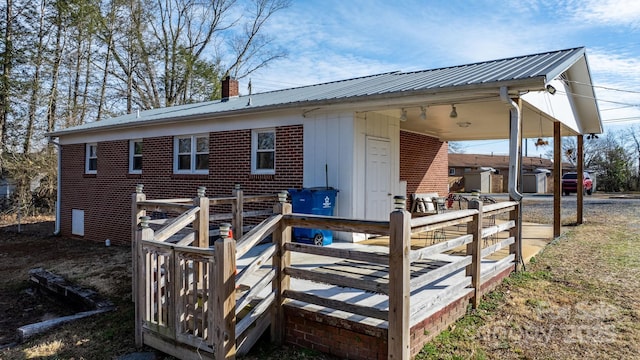 back of house featuring a wooden deck and a hot tub