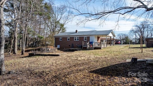 back of property featuring a lawn