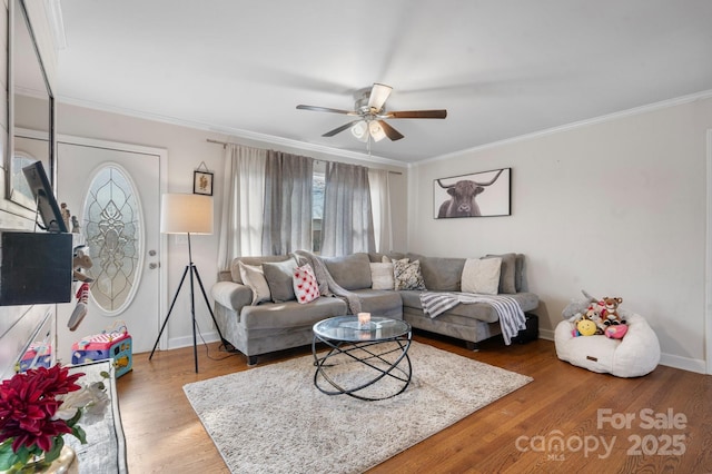 living room featuring hardwood / wood-style flooring, ornamental molding, and ceiling fan