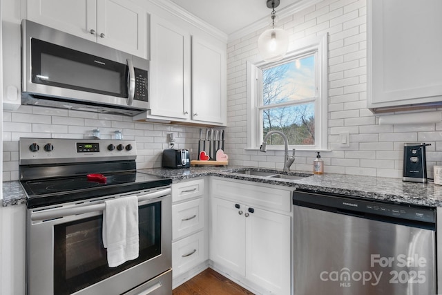 kitchen featuring sink, stainless steel appliances, white cabinets, and stone counters