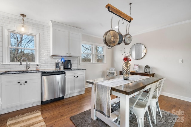 kitchen featuring decorative light fixtures, dishwasher, sink, white cabinets, and dark hardwood / wood-style flooring