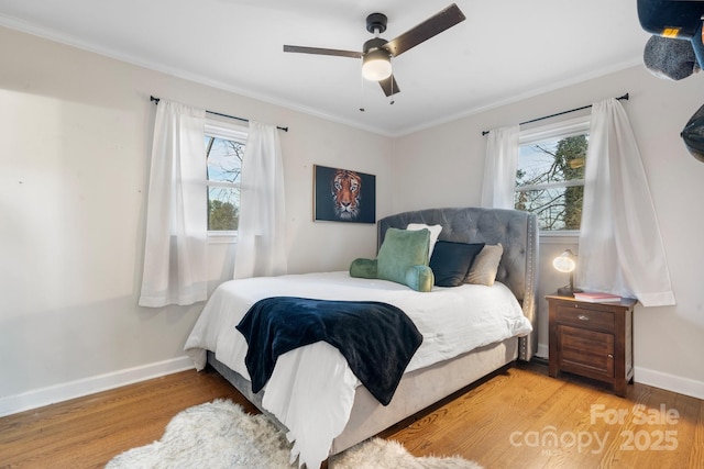 bedroom featuring ornamental molding, ceiling fan, and light hardwood / wood-style flooring