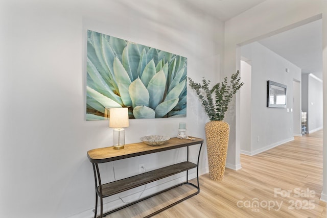 hallway with baseboards and wood finished floors