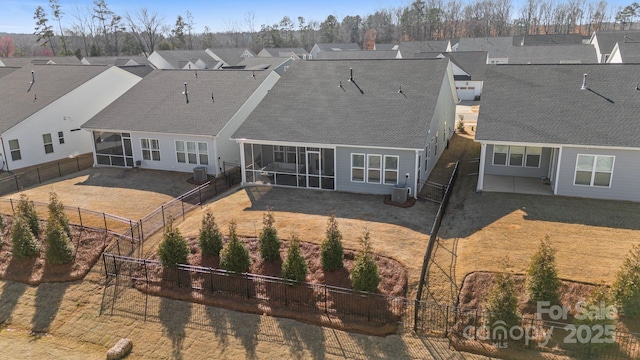 back of house with a patio area and a sunroom