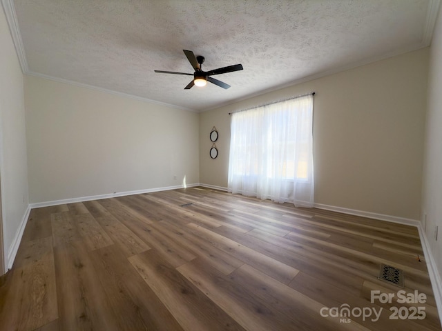 empty room with hardwood / wood-style flooring, ceiling fan, crown molding, and a textured ceiling