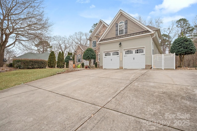 view of side of property featuring a garage and a lawn