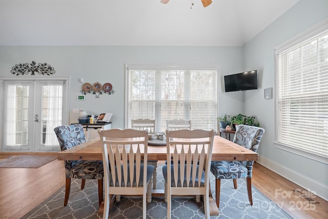 dining space with french doors, a healthy amount of sunlight, and hardwood / wood-style floors