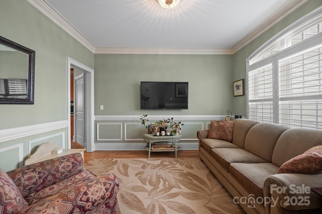 living room with light hardwood / wood-style flooring and crown molding