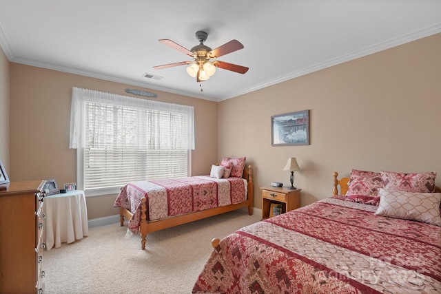 carpeted bedroom featuring ceiling fan and crown molding