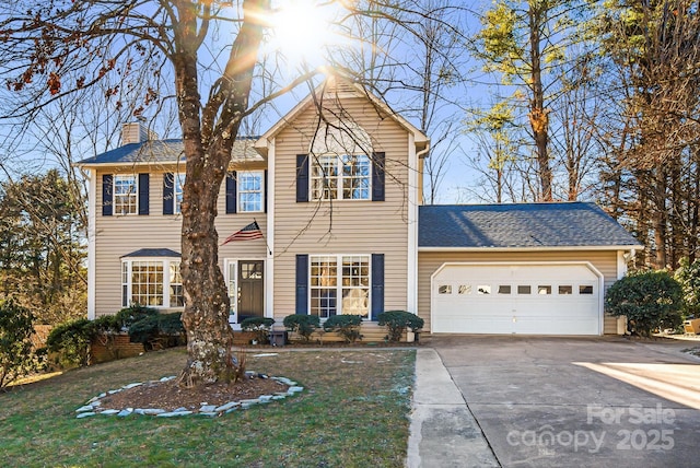 view of front of home featuring a garage and a front yard