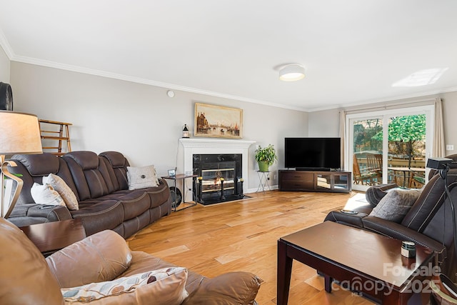 living room with a fireplace, wood-type flooring, and ornamental molding