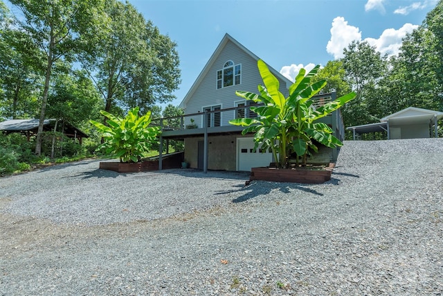 exterior space featuring a garage and a wooden deck