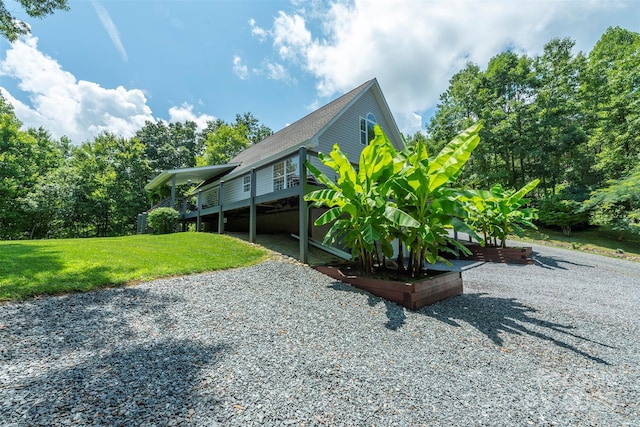 view of side of property featuring a deck and a lawn