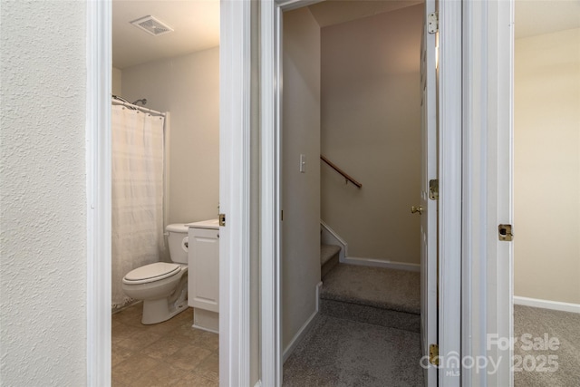 bathroom featuring vanity, toilet, and a shower with shower curtain