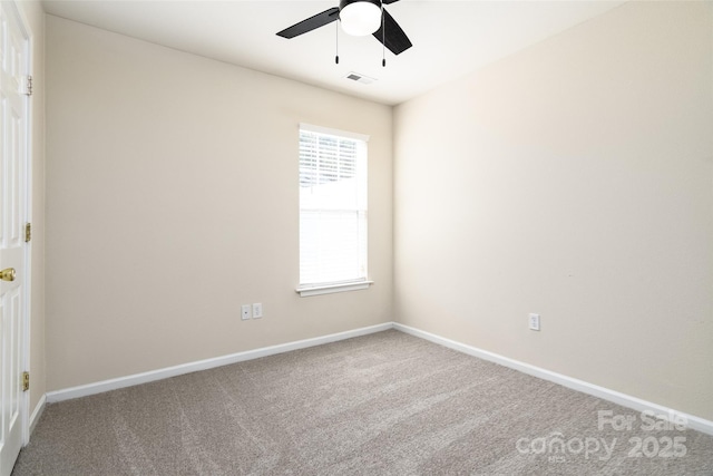 carpeted spare room with ceiling fan