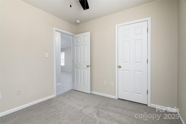 unfurnished bedroom with ceiling fan and light carpet