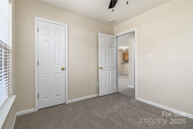 unfurnished bedroom featuring a closet, ceiling fan, and carpet floors