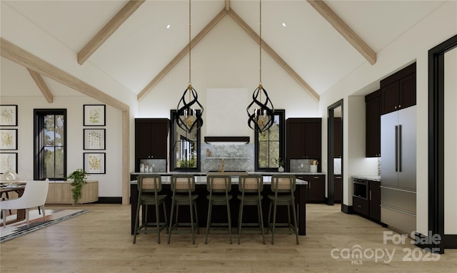 kitchen featuring dark brown cabinetry, a kitchen bar, high vaulted ceiling, and a kitchen island