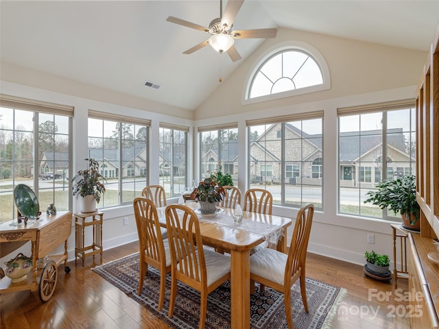 sunroom with ceiling fan and vaulted ceiling