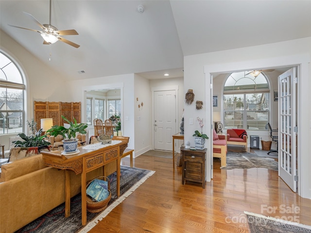 interior space with a wealth of natural light, light hardwood / wood-style flooring, and vaulted ceiling