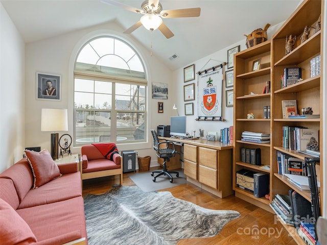 office space with ceiling fan, hardwood / wood-style flooring, and lofted ceiling