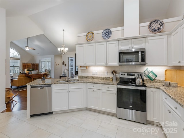 kitchen with white cabinetry, lofted ceiling, and stainless steel appliances