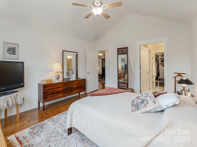 bedroom with hardwood / wood-style floors, vaulted ceiling, and ceiling fan