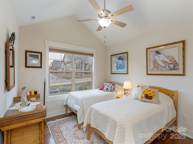 bedroom featuring ceiling fan, hardwood / wood-style floors, and vaulted ceiling