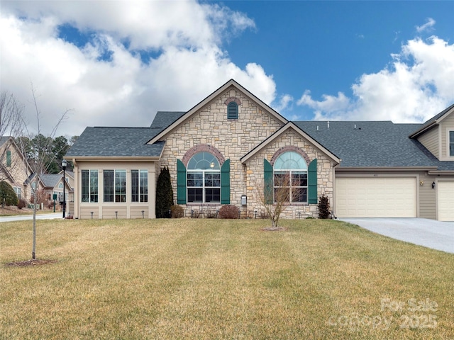 ranch-style home with a garage and a front lawn