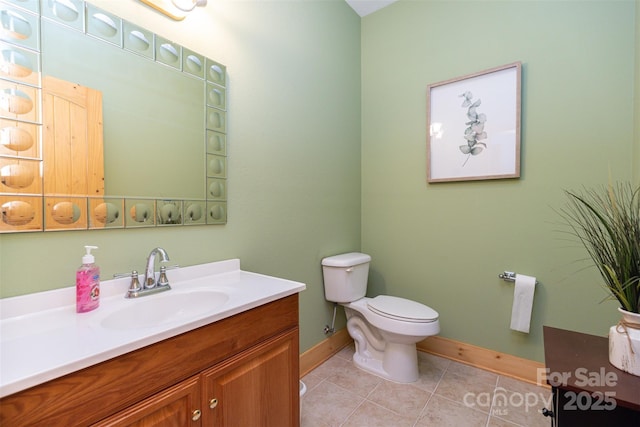 bathroom with tile patterned flooring, vanity, and toilet