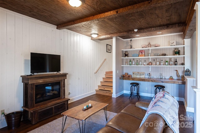 living room with dark wood-type flooring, indoor bar, wood ceiling, and beamed ceiling