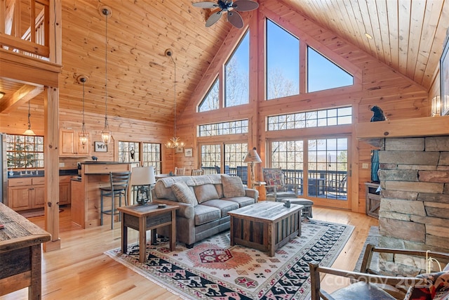 living room with wood walls, wooden ceiling, and light hardwood / wood-style flooring