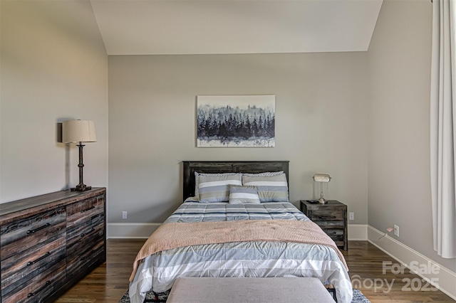 bedroom with dark hardwood / wood-style flooring and lofted ceiling