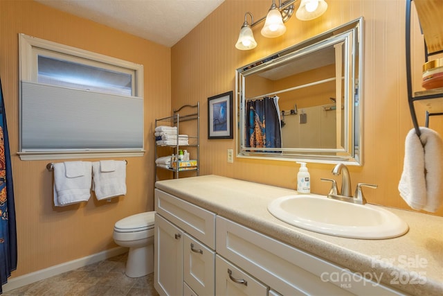 bathroom featuring vanity, toilet, a shower with shower curtain, and a textured ceiling