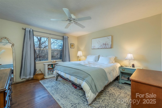 bedroom with hardwood / wood-style floors, a textured ceiling, and ceiling fan