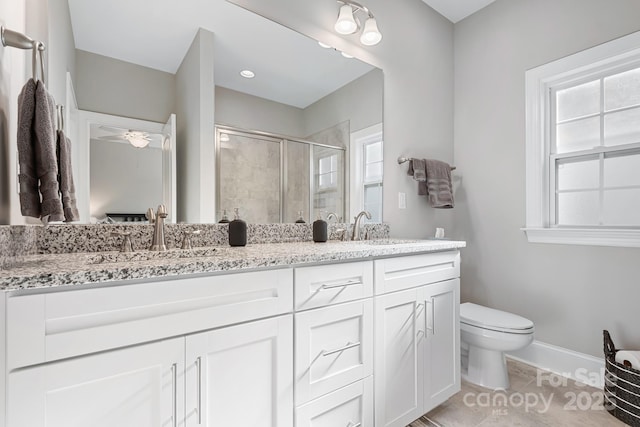 bathroom with vanity, toilet, tile patterned flooring, and a shower with door