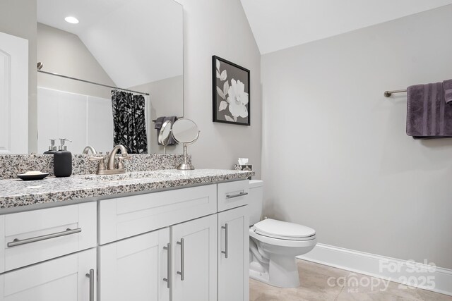 bathroom featuring lofted ceiling, tile patterned flooring, vanity, a shower with curtain, and toilet