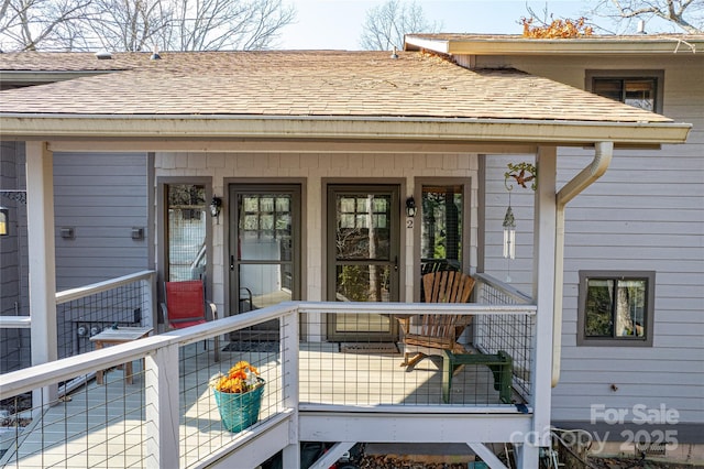 property entrance with a shingled roof