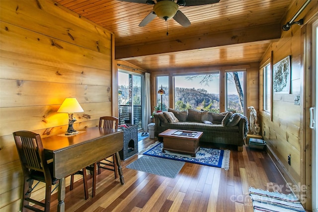 living room featuring wooden ceiling, wood finished floors, and a healthy amount of sunlight