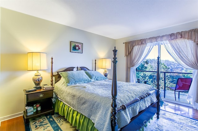 bedroom with baseboards and wood finished floors