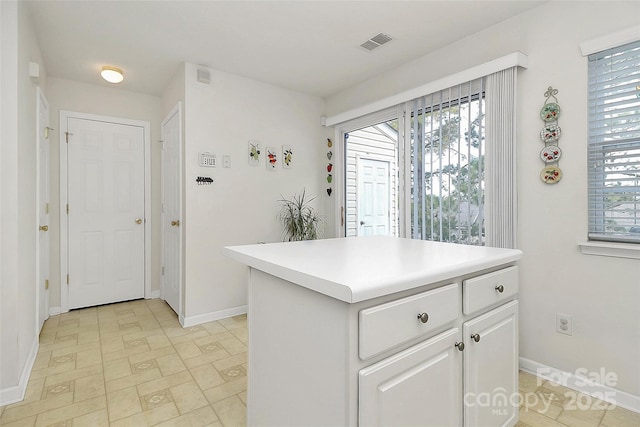 kitchen featuring white cabinetry and a center island