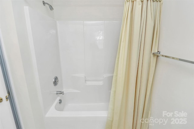 bathroom with shower / bathtub combination with curtain