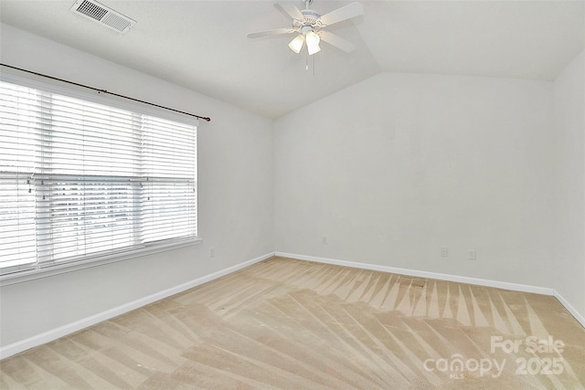 unfurnished room featuring vaulted ceiling, light colored carpet, and ceiling fan